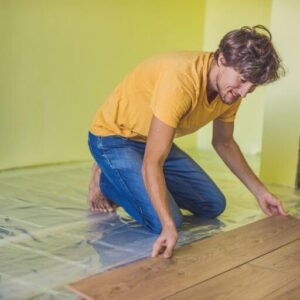 Man installing| underfloor heating | Building Material Reviews 