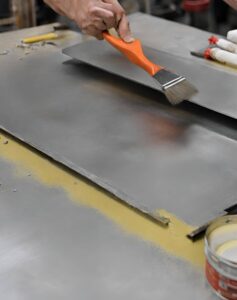 Metal being Prepared for Painting | Building Material Reviews