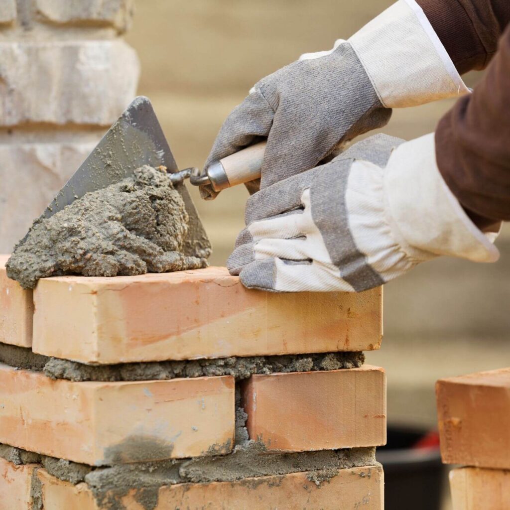 Builder laying Bricks | Building Material Reviews 