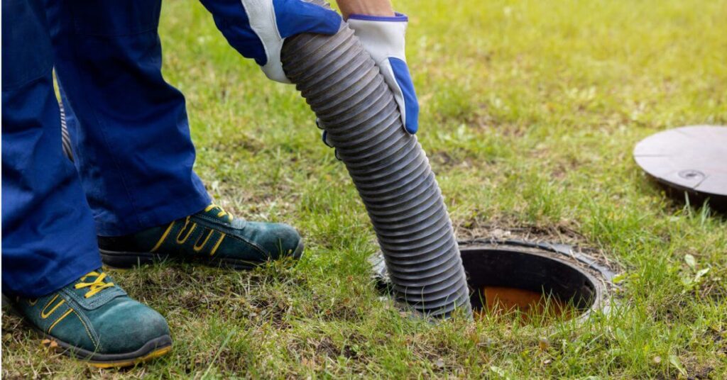 Worker clearing out drains | building material reviews 