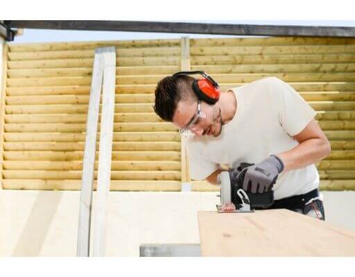 Construction Worker cutting Timber | Building Material Reviews