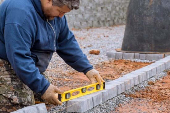 Homeowner laying Edging Stones | Building Material Reviews