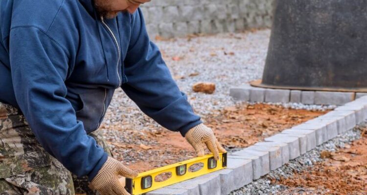 Homeowner laying Edging Stones | Building Material Reviews