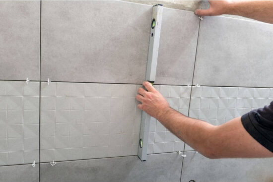 Tilers applying Tiles onto Studs | Building Material Reviews